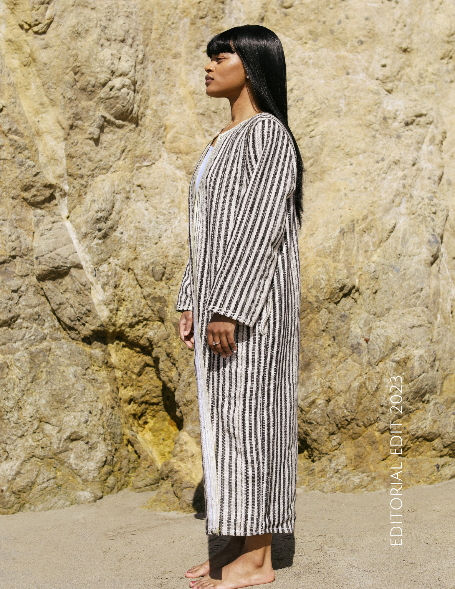 Model wearing Kaftan Trench Coat walking along Malibu Beach 
